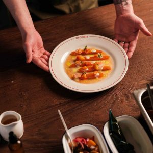 A dish from the A La Carte menu being plated on the pass