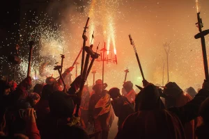 Ferragosto celebrations in Italy with fire and people.