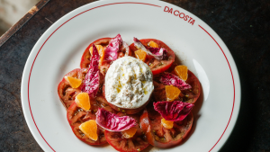 Burrata and winter tomato salad on plate