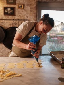 Chef piping pasta filling