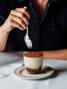 A spoon going into tiramisu
