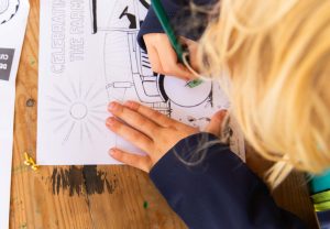 Family friendly dining at Da Costa. Child colouring in a drawing.