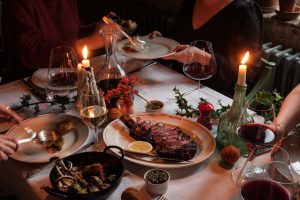Festive dinner with roast and wine.